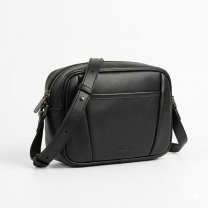 Black leather crossbody bag on a light gray background