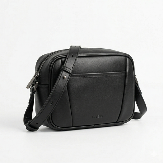 Black leather crossbody bag on a light gray background