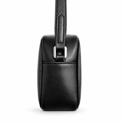 Black leather handbag with a strap on a white background